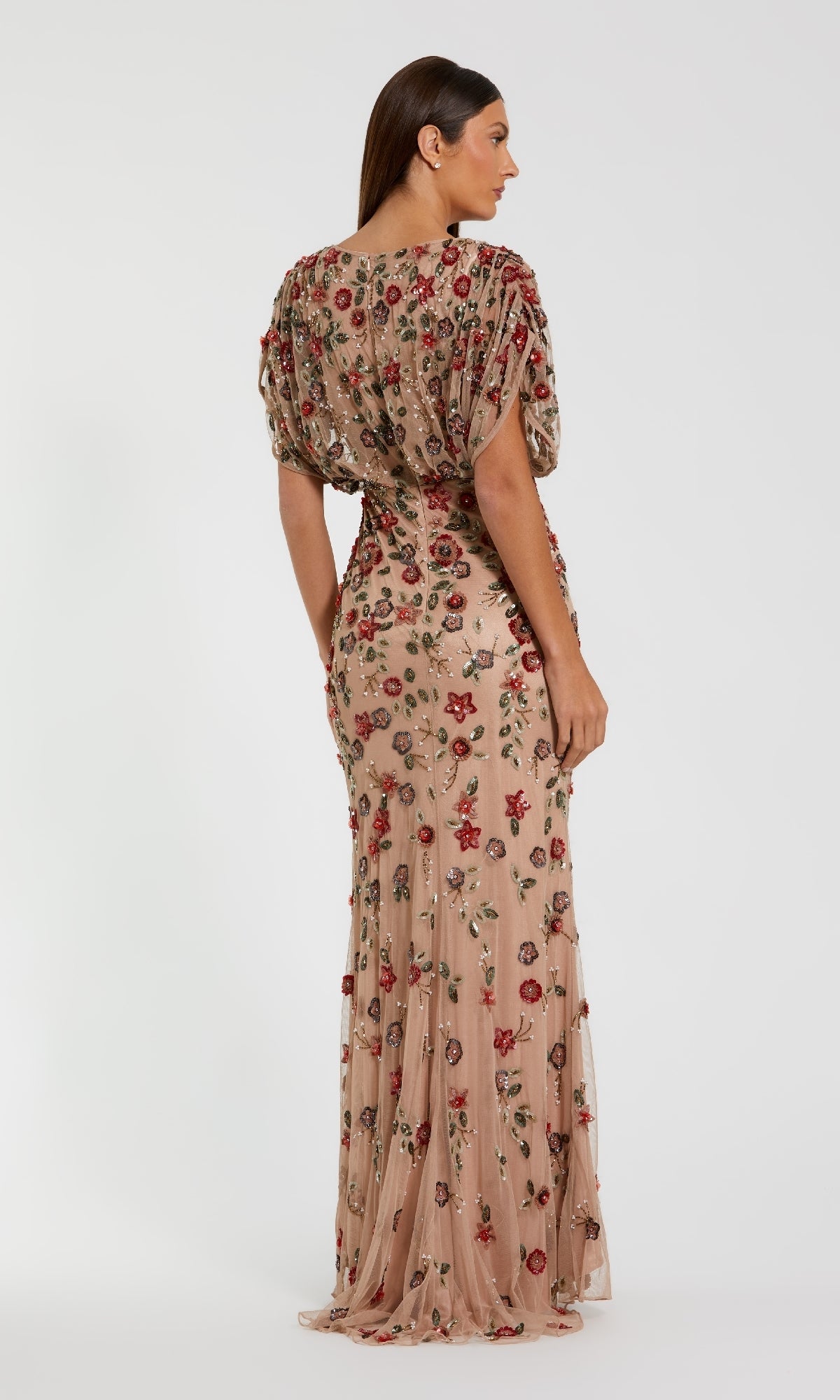 A woman stands facing away against a white background, wearing the Mac Duggal 6158—an elegant short sleeve beaded formal dress.